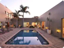 Relax around the pool at Sunset Game Lodge