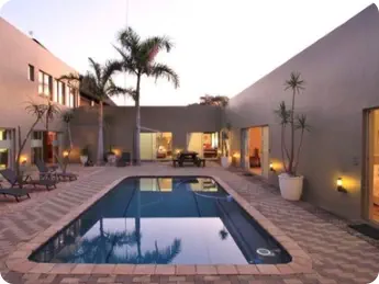 Relax around the pool at Sunset Game Lodge